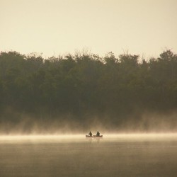 A canoe in the early morning mist of Miller Lake