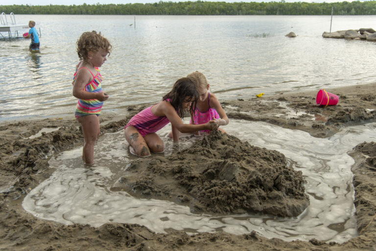 Kids building a sandcastle on the beach at Miller's Family Camp