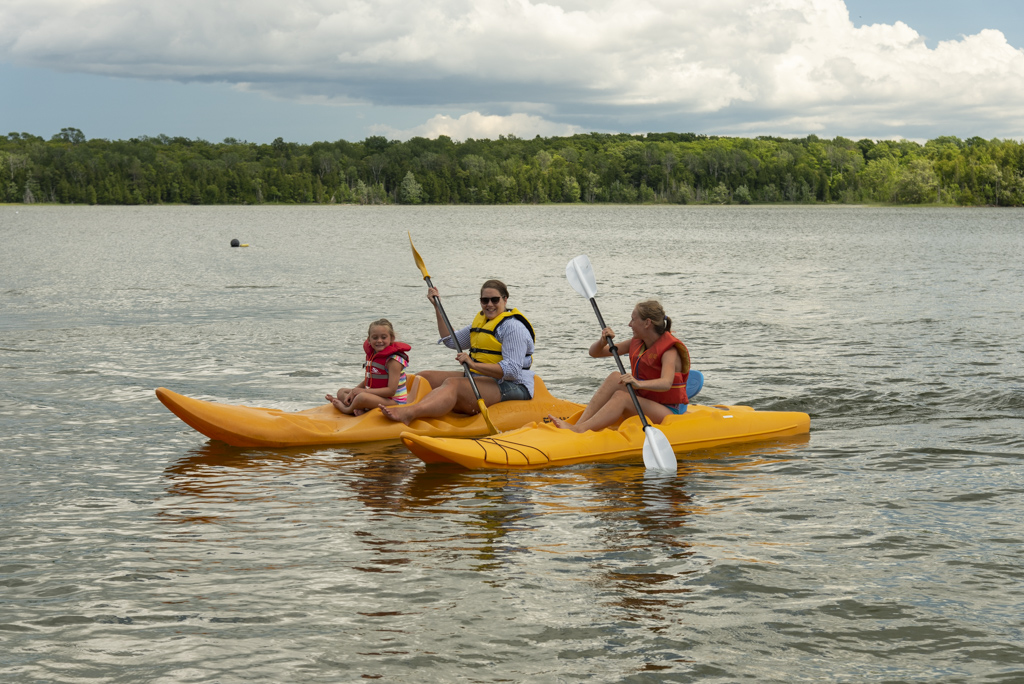 Family kayaking on Miller Lake from Miller's Family Camp