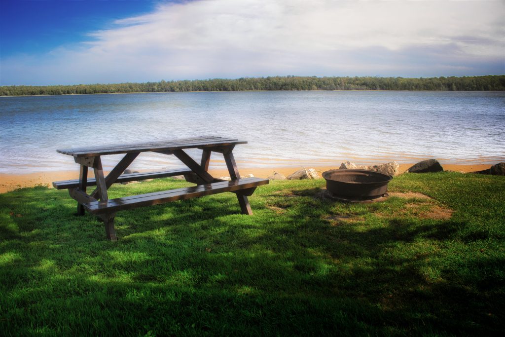 picnic table and fire pit on edge of Miller Lake